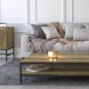 handmade two tier coffee table with wood finish placed in front of white sofa