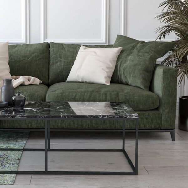 handmade marble coffee table in front of dark green sofa