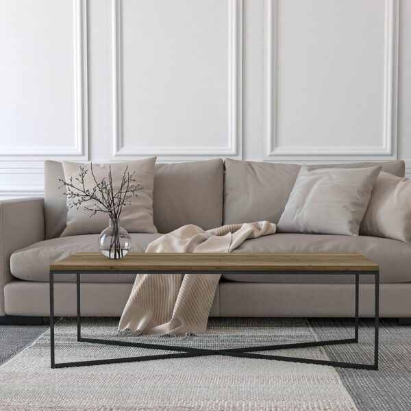 handmade linear X coffee table with wood finish, placed in front of grey sofa